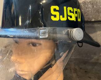 Vintage Cairns SJSFD Fire Helmet with shield on vintage Jake Burmax mannequin head