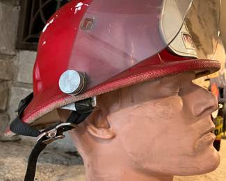 Vintage Cairns Red Lieutenant Fire Helmet with shield and leather badge, on vintage mannequin head