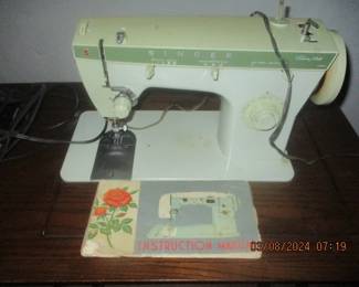 Vintage Singer sewing machine in cabinet