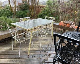 In the back yard you will find the Mid-Century table with 4 chairs, metal round table with 2 chairs