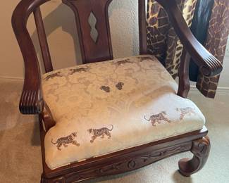 A close look at the oriental wood carved arm chair with tiger upholstered seat