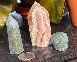 Crazy Lace Agate in the middle, Green Aventurine point on left and skull on right.