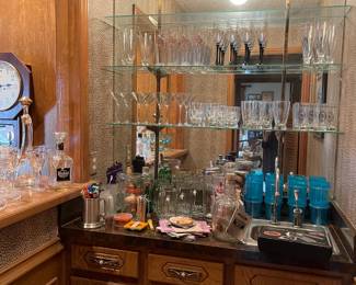 Looking into the bar area with great vintage glass, coasters, cocktail sticks and bar tools