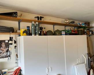White storage cupboards, helmets, flasks, and more