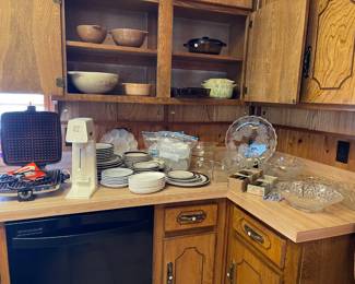 Looking at vintage Pyrex, milk glass egg plates, vintage glass serving pieces, waffle iron and drink mixer