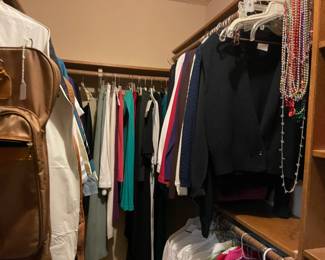 Looking into the master closet full of ladies clothing including vintage