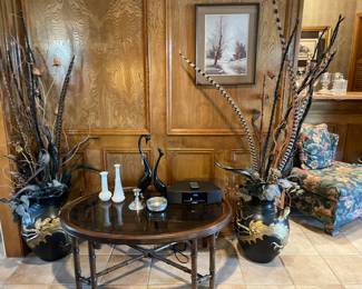 Beautiful vintage black and gold dragon urns with dried floral arrangements. Vintage milk glass, pewter pieces, Mid-Century Egret sculptures, vintage bamboo style glass top coffee table