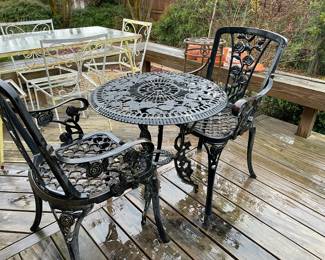 A close look at the metal round table with two chairs