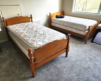 A pair of twin size pine beds