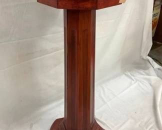 DISPENSER SITTING ON WOODEN PEDESTAL