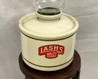 DISPENSER SITTING ON WOODEN TABLE BASE