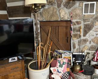 hand carved walking sticks, childs rocking chair, vintage popcorn popper, quilt bear