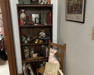 walnut bookcase , caned chair , quilted cat 