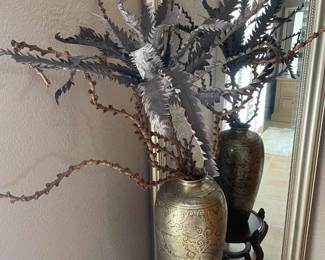 floor length silver frame mirror and artificial plant in vase