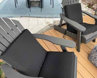 Adjustable (!) adirondack chairs with polymer construction in black with cushions. 