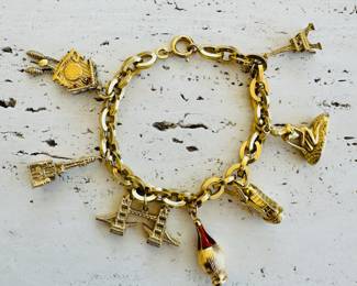 Marked 750 (18kt) gold charm bracelet with 7 - 750 marked charms