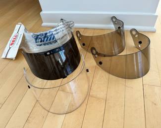 Vintage racing helmet shields including one still in its packaging