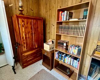 The pine entertainment  center/armoire, In the bookshelf filled with encyclopedias, DVD’s and VHS