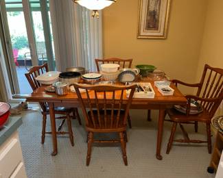 Expanding vintage dining table and chairs. A lot of Kitchenware on top of it.