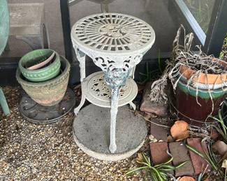 There are a lot of outdoor pots and plant stands too