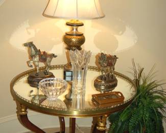 Round mirrored table with brass lamp