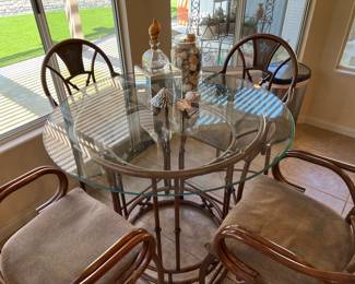 High top featuring painted palm tree designs on the back of each chair 