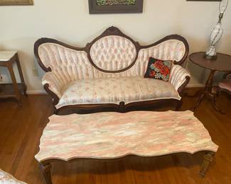 Victorian chic sofa and pink marble coffee table.