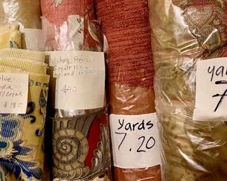 Several large rolls of upholster fabric w/high yardage. Not all pictured. There is also an older Adler industrial sewing machine. It must weight 60 Lbs take for free!
