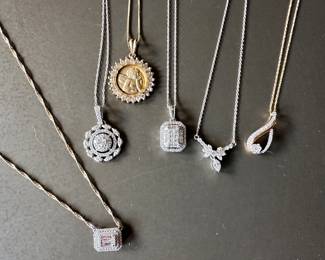 From left to right: 14k diamond pendant set east-west on a yellow gold chain, 14k vintage diamond medallion, 14k yellow gold cherub medallion, 10k diamond art deco princess cut pendant, 14k vintage marquis diamond bow neck, 10k rose gold diamond infinity pendant perfect gifts for graduation!