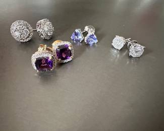 14k gold and diamond studs. Purple stones are cushion cut African Amethyst with diamond halo. Trillion cut Tanzanite studs.