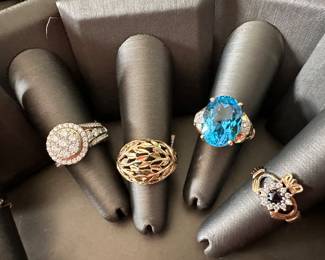 Gold statement rings from left to right: 14k 1ctw diamond ring, 10k dome gold leaf band, 14k blue topaz and diamond large statement ring, 14k sapphire claddaugh ring