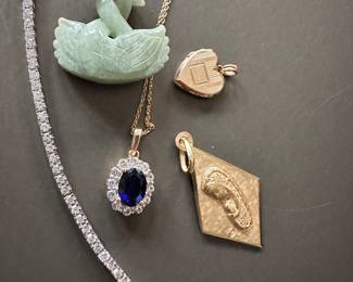 Diamond tennis bracelet, 18k gold Virgin Mary Pendant, 10k gold sweet heart locket, carved jade swans (would make a very cool layering statement), 10k created sapphire and white topaz oval halo pendant