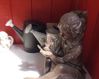 Statue and watering cans 