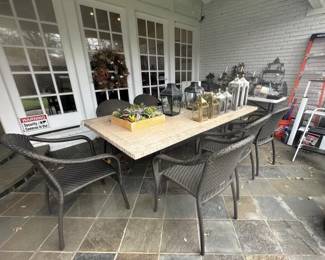 Stone top patio dining table and eight Frontgate wicker style chairs