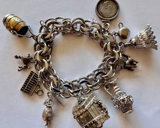 Vintage Charm Bracelet With Sterling Clasp & 10 Charms, Some Marked Sterling, Chest By Monet
Lot #: 27