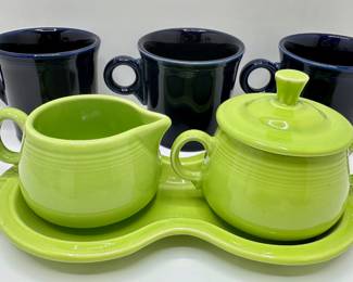 7 Fiesta Ware Pieces: Green Sugar Bowl With Creamer On Tray & 3 Blue Mugs
Lot #: 81