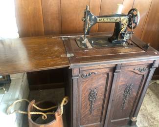 Antique sewing machine and cabinet