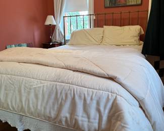 Queen frame with a full mattress and bedding