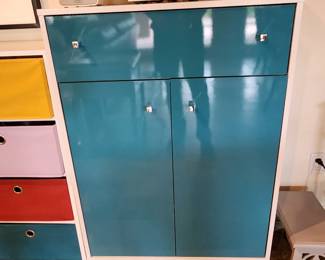 Love this turquoise and white cabinet with its cute legs