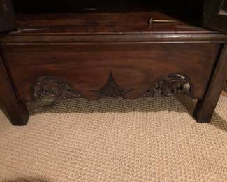 Showing carving detail on bottom front of display cabinet.