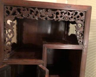 Showing carving detail on display cabinet.
