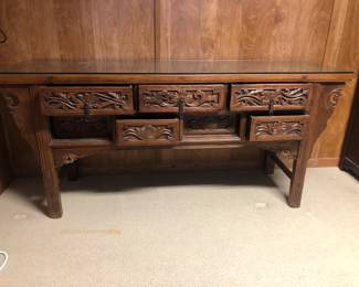 7 Drawer Chinese Carved Altar Table. The bottom drawers toggle. Push one drawer in to open the adjacent drawer.