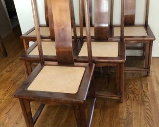6 Walnut armless dining chairs with wicker inset seat. (Selling with the dining table)