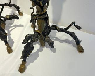 Feet of pair of bronze candelabras with dogs at the top, vines, and hooves for feet