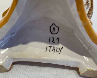 Bottom of Pair of Italian Faience Griffin candle holders, stamped 127 Italy on the bottom