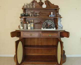Gorgeous antique oak and marble top sideboard, shown with cabinet doors open