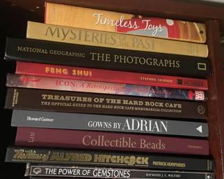 Book collection including: "Timeless Toys", "Mysteries of the Past", "National Geographic: The Photographs", "Feng Shui", "Icon: A Retrospective", "Treasures of the Hard Rock Cafe", "Gowns by Adrian", "Collectable Beads", "Alfred Hitchcock", "The Power of Gemstones"