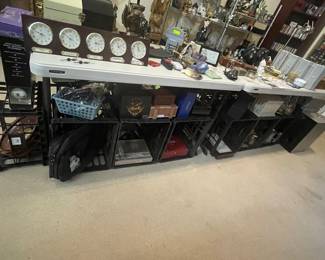 Tables and crates full of unique and interesting home goods and decor including a five time-zone clock world clock