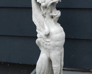 Side view of Griffin white stone sculpture