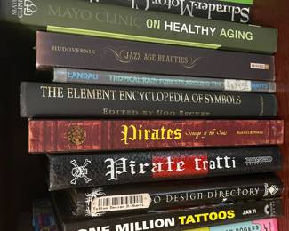 Book collection including: "Mayo Clinic on Healthy Aging", "Jazz Age Beauties", "Tropical Rain Forests Around the World", "The Element Encyclopedia of Symbols", "Pirates: Scourge of the Seas", "Pirate Tratti", "Tattoo Design Directory", "One Million Tattoos"